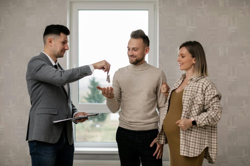 A man holding a key to his new apartment.
