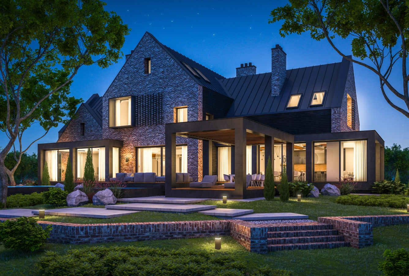 A large house with lights on in the evening.